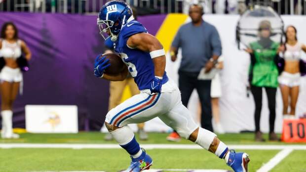 Saquon Barkley runs the ball in the NFL Playoffs.