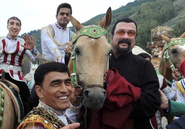 CHOLPON-ATA, KYRGYZSTAN - SEPTEMBER 4, 2016: Hollywood actor Steven Seagal (R) and people in traditional dress in a specially built village setting, Kyrchin, at the 2016 World Nomad Games. Viktor Drachev/TASS (Photo by Viktor DrachevTASS via Getty Images)
