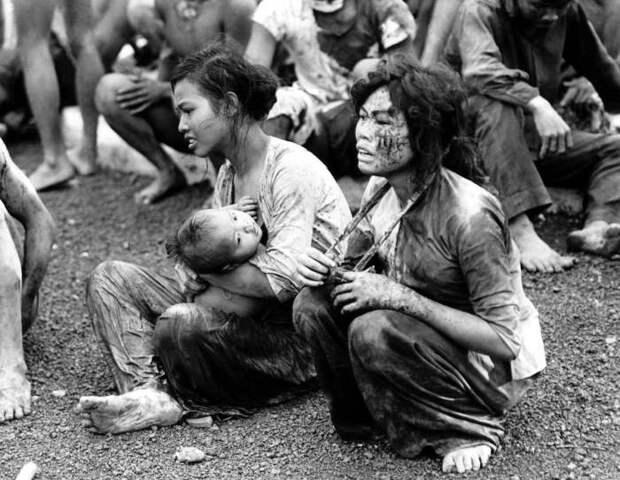 Изнеможённые мирные люди, которые вышли из своих подземных укрытий после двухдневной бомбардировки и изнурительных боёв в окрестностях города Dong Xoai, 6 июня 1965 года.