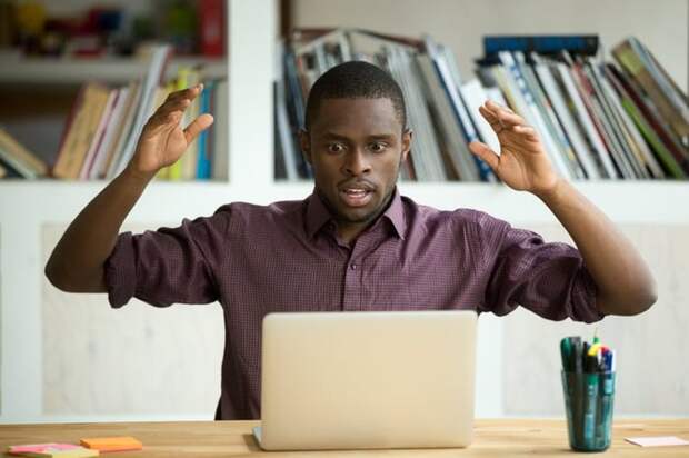 Shocked man looking at laptop