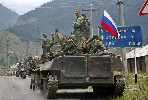 A column of Russian armored vehicles, heading towards the breakaway Georgian province of South Ossetia, are seen in North Ossetia, Russia, Friday, Aug. 8, 2008. A surprise military offensive by Georgia, a staunch U.S. ally, to retake the breakaway province of South Ossetia reportedly killed hundreds of people Friday, triggering a ferocious counterattack from Russia that threatened to plunge the region into full-scale war. (AP Photo/Musa Sadulayev)