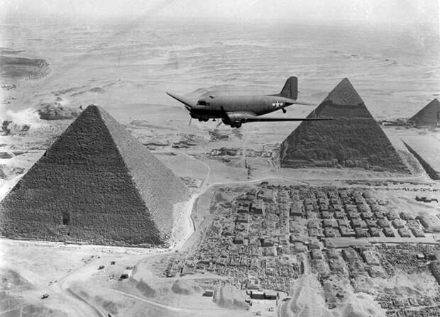 Транспортный самолет США Douglas C-47 Skytrain пролетает над некрополем Гизы в Египте, 1943 год.
