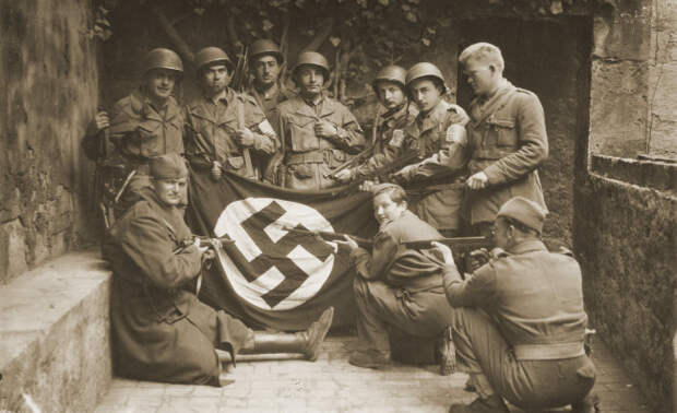 09 - Yugoslav partisans and the US soldiers with captured Nazi flag at the island of Vis Yugoslavia modern day Croatia
