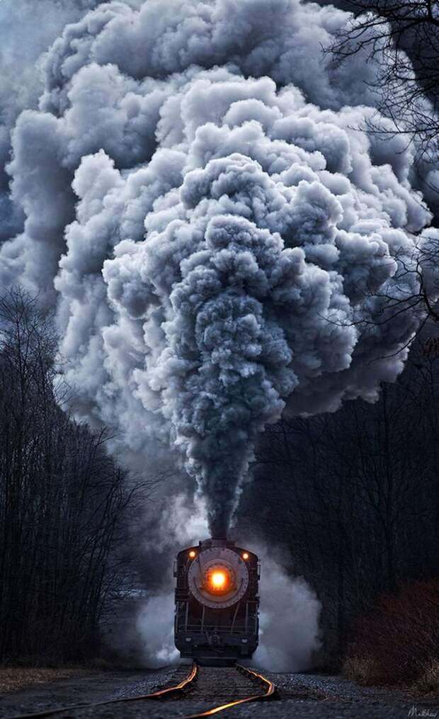 Powerful steel engines blowing huge, undulating clouds of smoke into the air emerge from the fog in these strikingly beautiful images by engineer and self-taught photographer Matthew Malkiewicz.: 