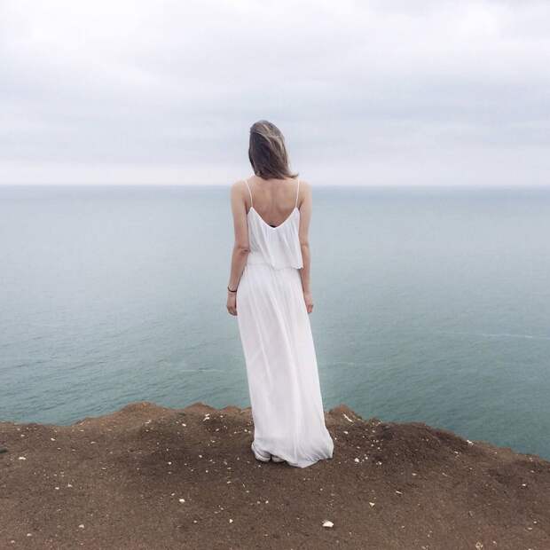 woman-in-white-spaghetti-strap-dress-standing-on-cliff-1030901