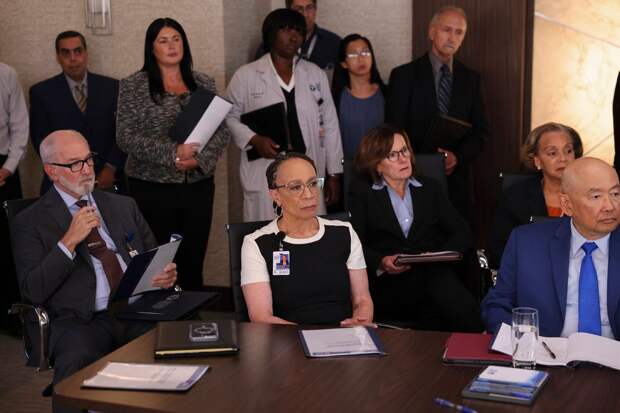 The hospital board sitting and standing around a table on Chicago Med Season 10 Episode 3