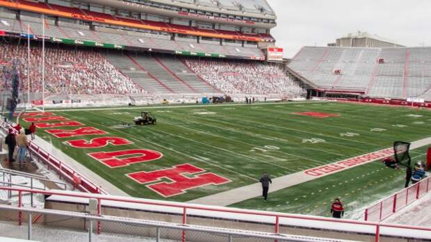 A view of Memorial Stadium as workers clear the field of snow.