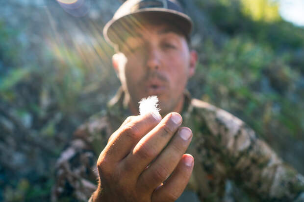 brett seng holding a feather