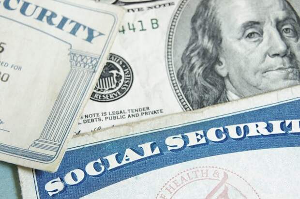 Two Social Security cards and a $100 bill.