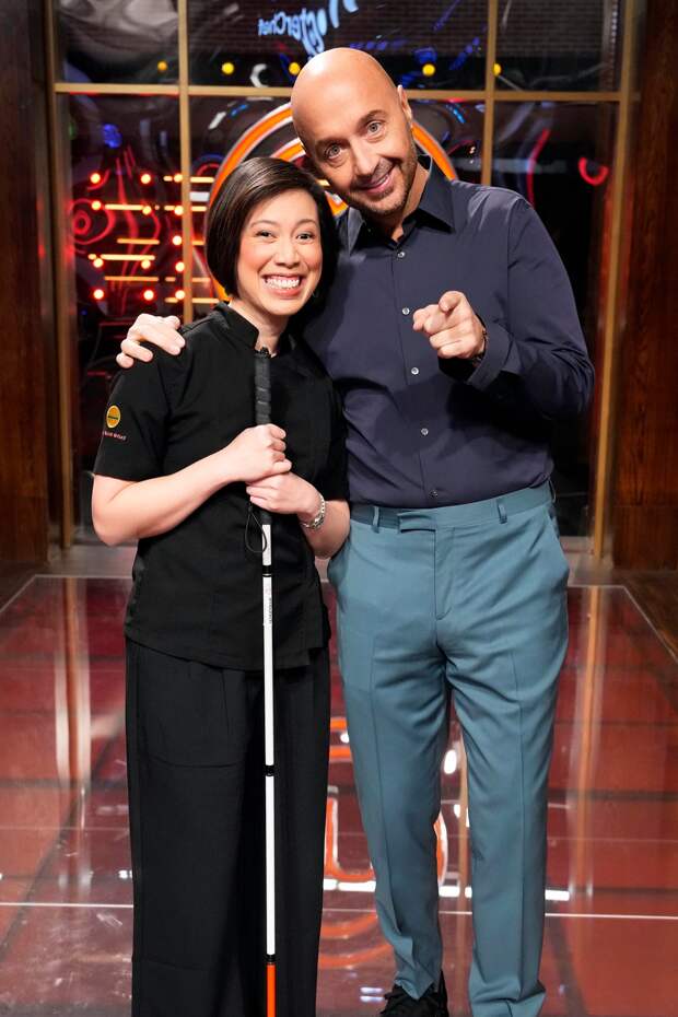 Joe Bastianich smiles and hugs Masterchef alum Christine Ha.