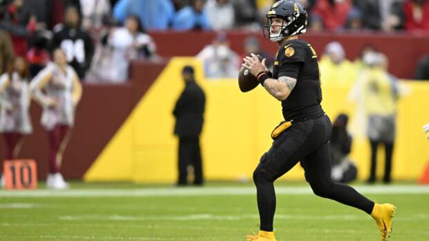 Taylor Heinicke looks to make a pass.
