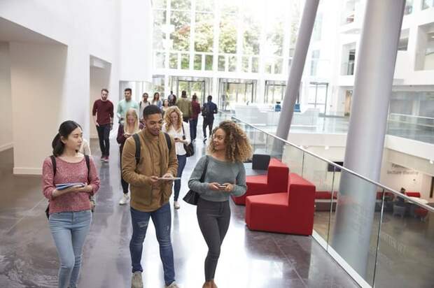 A group of college students walking out of class.