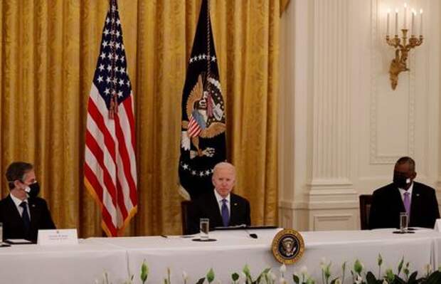 U.S. President Joe Biden is flanked by Secretary of State Antony Blinken and Defense Secretary Lloyd Austin as he holds a Cabinet meeting in the East Room at the White House in Washington, U.S., April 1, 2021. REUTERS/Tom Brenner