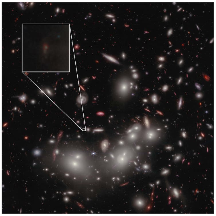 Bright lights (galaxies and a few stars) against a dark backdrop of sky. One faint galaxy is shown in a magnified box as a dim smudge.