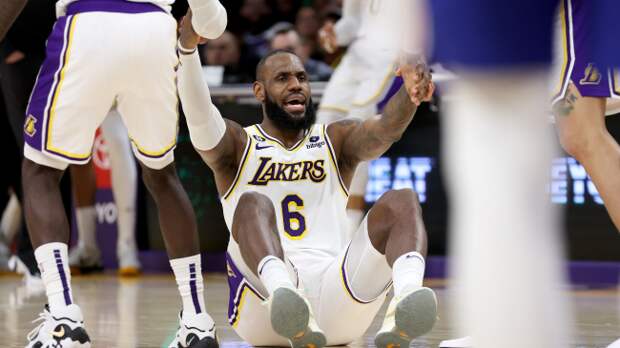 LeBron James is helped up off the floor.