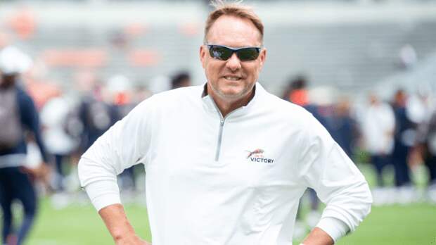Hugh Freeze on the field before an Auburn football game.