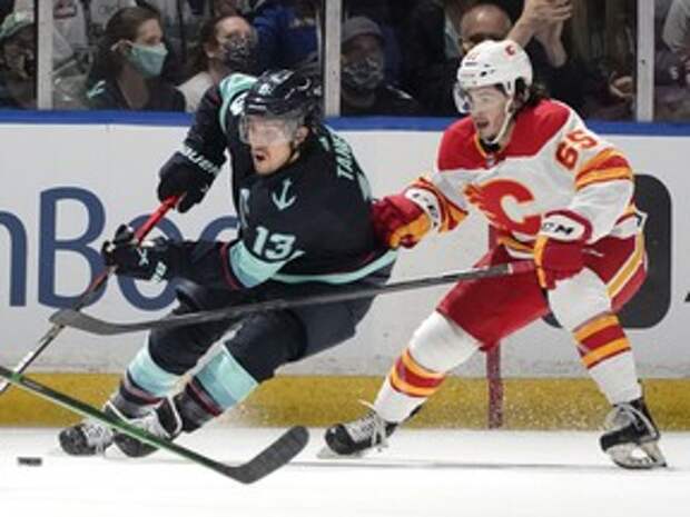 The Calgary Flames’ Ryan Francis chases the Seattle Kraken’s Brandon Tanev during their preseason game in Kent, Wash., on Saturday, Oct. 2, 2021.