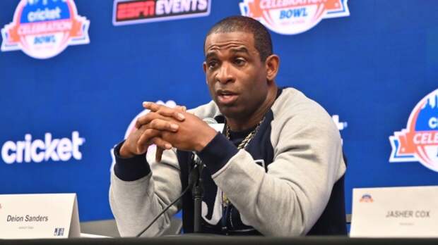 Deion Sanders speaking at a pre-game press conference