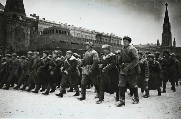 Участники Парада идут мимо трибуны Мавзолея.