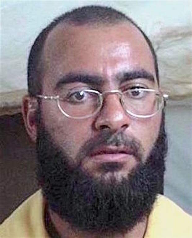 https://upload.wikimedia.org/wikipedia/commons/thumb/1/1a/Mugshot_of_Abu_Bakr_al-Baghdadi%2C_2004.jpg/267px-Mugshot_of_Abu_Bakr_al-Baghdadi%2C_2004.jpg