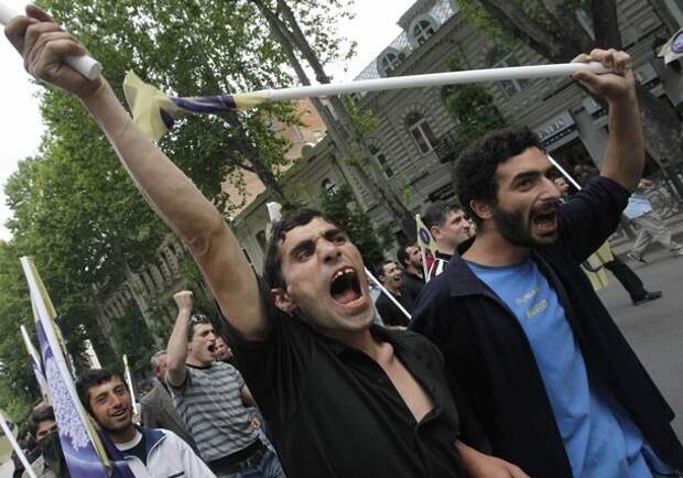 Opposition supporters shout slogans during a rally in Tbilisi