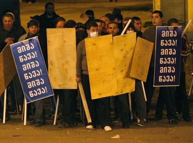 Activists hold sticks and wooden shields as they prepare to defend themselves during an overnight opposition rally in Tbilisi