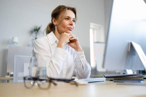 A person looking at a computer monitor.
