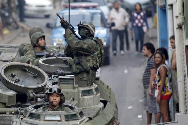 Brazilian Navy soldiers patrol in an armoured vehicle during an operation against drug dealers at Mangueira slum in Rio de Janeiro