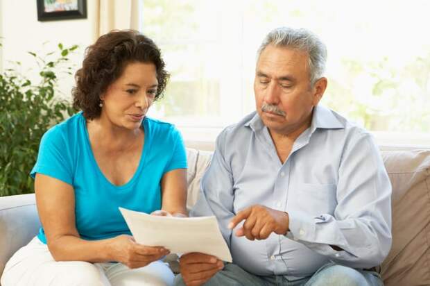 Couple discussing document together.