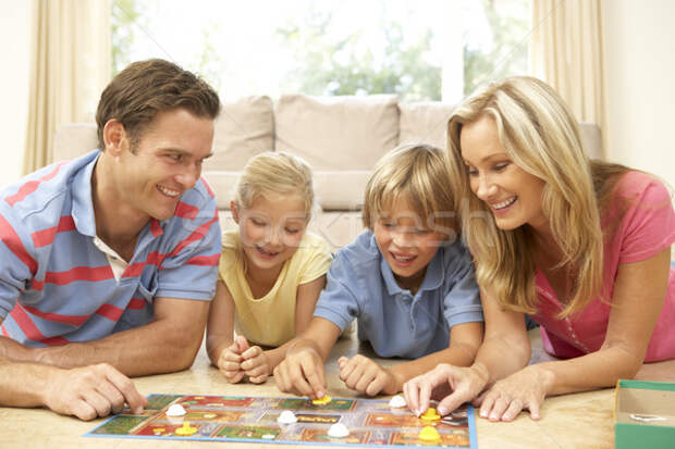 Stock photo: Family Playing Board Game At Home