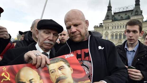 Американский боец Джефф Монсон держит изображение Иосифа Сталина и Владимира Ленина