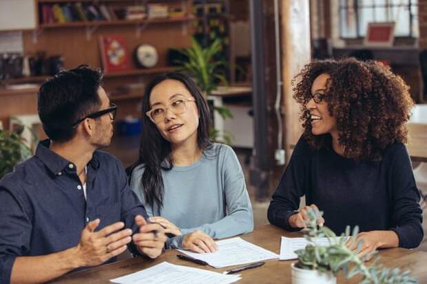 A couple receives financial advice from an associate.