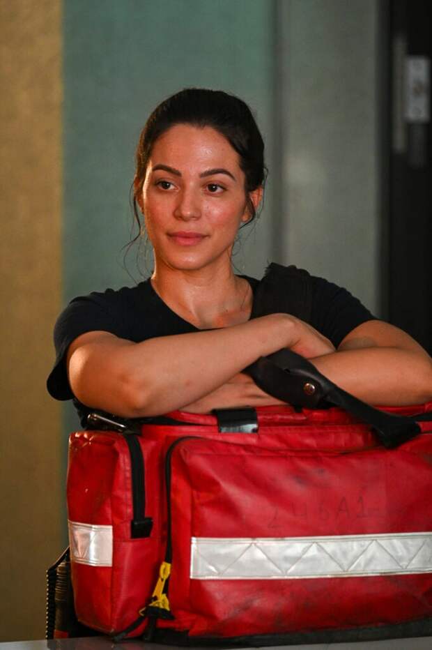 Gabriela leans on a medical bag