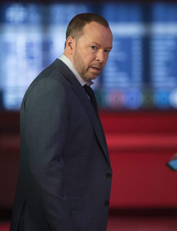 Danny standing and looking shocked with his hands in his pockets on Blue Bloods Season 14 Episode 18