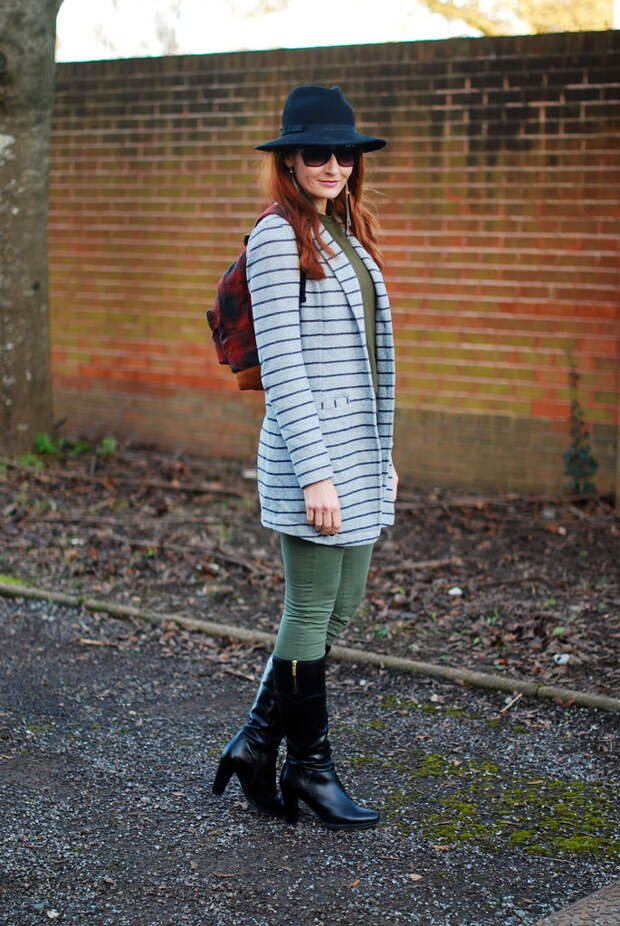 Striped longline blazer with black boots, plaid rucksack and fedora
