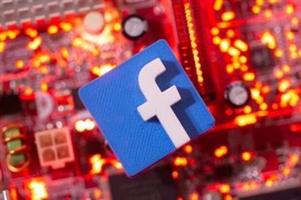A 3D printed Facebook logo is placed on a computer motherboard in this illustration taken January 21, 2021. REUTERS/Dado Ruvic/Illustration 
