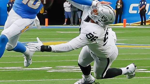 Isaac Rochell receives a stiff arm from Chargers QB Justin Herbert.