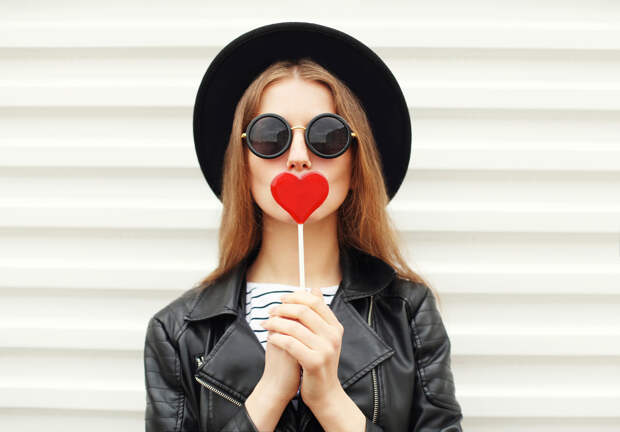 Fashion sweet woman having fun with lollipop over white background