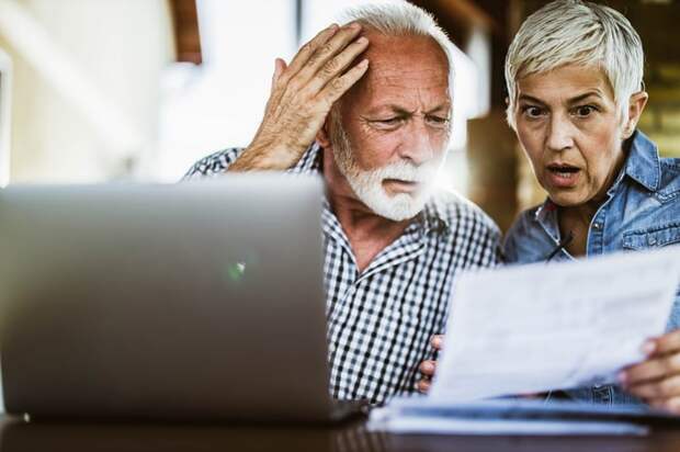 Two surprised people looking at papers.