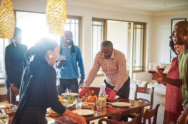 A family gathering around a full Thanksgiving table.