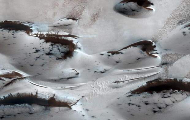 The northern-most sand dunes are seen as they begin to emerge from their winter cover of seasonal carbon dioxide (dry) ice.