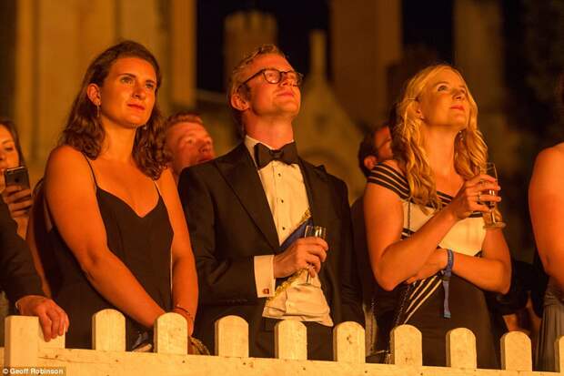 Star-struck: Delighted guests enjoy a glass of fizz as they watch the show-stopping firework display on Monday evening