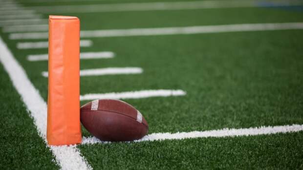 A football rests on a pylon.