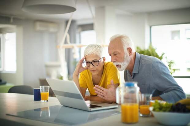 Worried people looking at laptop.