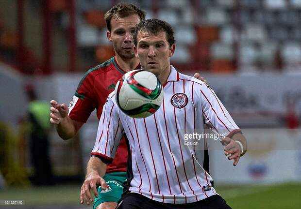 Roman Shishkin of FC Lokomotiv Moscow challenged by Aleksandr Prudnikov of FC Amkar Perm during the Russian Premier League match betweenFC Lokomotiv Moscow and FC Amkar Perm at Lokomotiv stadium on October 4, 2015 in Moscow, Russia.