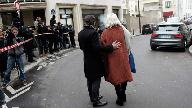 Люди стоят возле офиса издания Charlie Hebdo в Париже. Архивное фото Люди стоят возле офиса издания Charlie Hebdo в Париже. Архивное фото