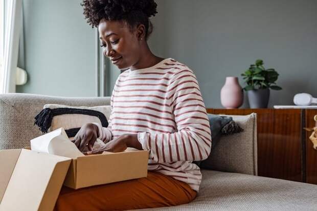 Woman packing up box to return item.