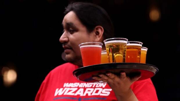 Man serving beer at NBA game