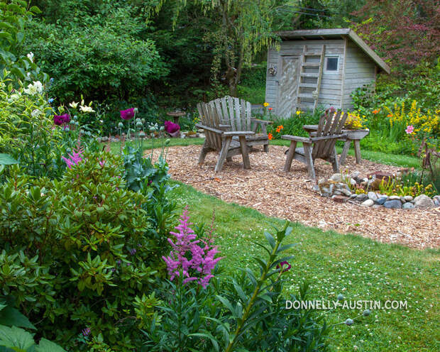 Vashon Island, Washington<br /> Garden shed and chairs with flower beds bordering a conversation area