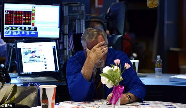 Traders wait anxiously after the NYSE halted all trading, for 'technical reasons' - but says the problem is an internal one and not the result of a cyberattack.